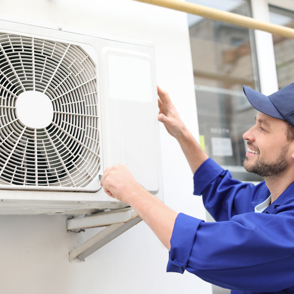 Technician installing a new outdoor air conditioning unit beside a Florida home