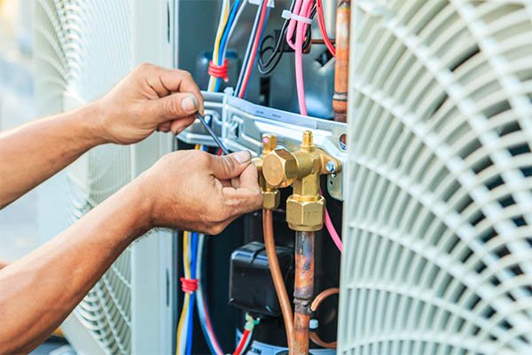 Technician repairing a residential air conditioning system in Bay County Florida